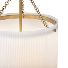 Close-up of a pendant light with gold chain and white shade on a white background