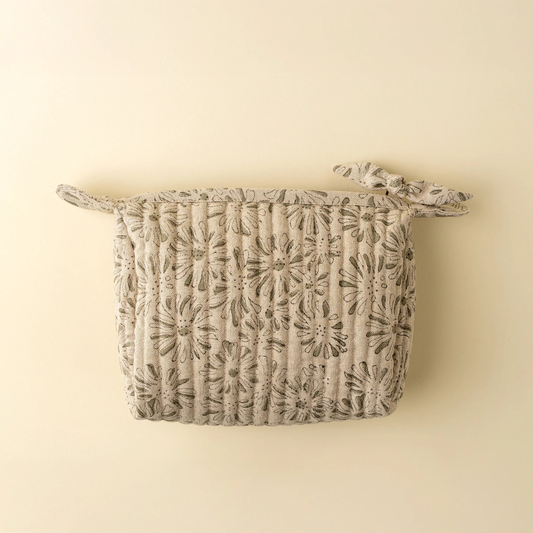 Floral-patterned pouch on a beige background