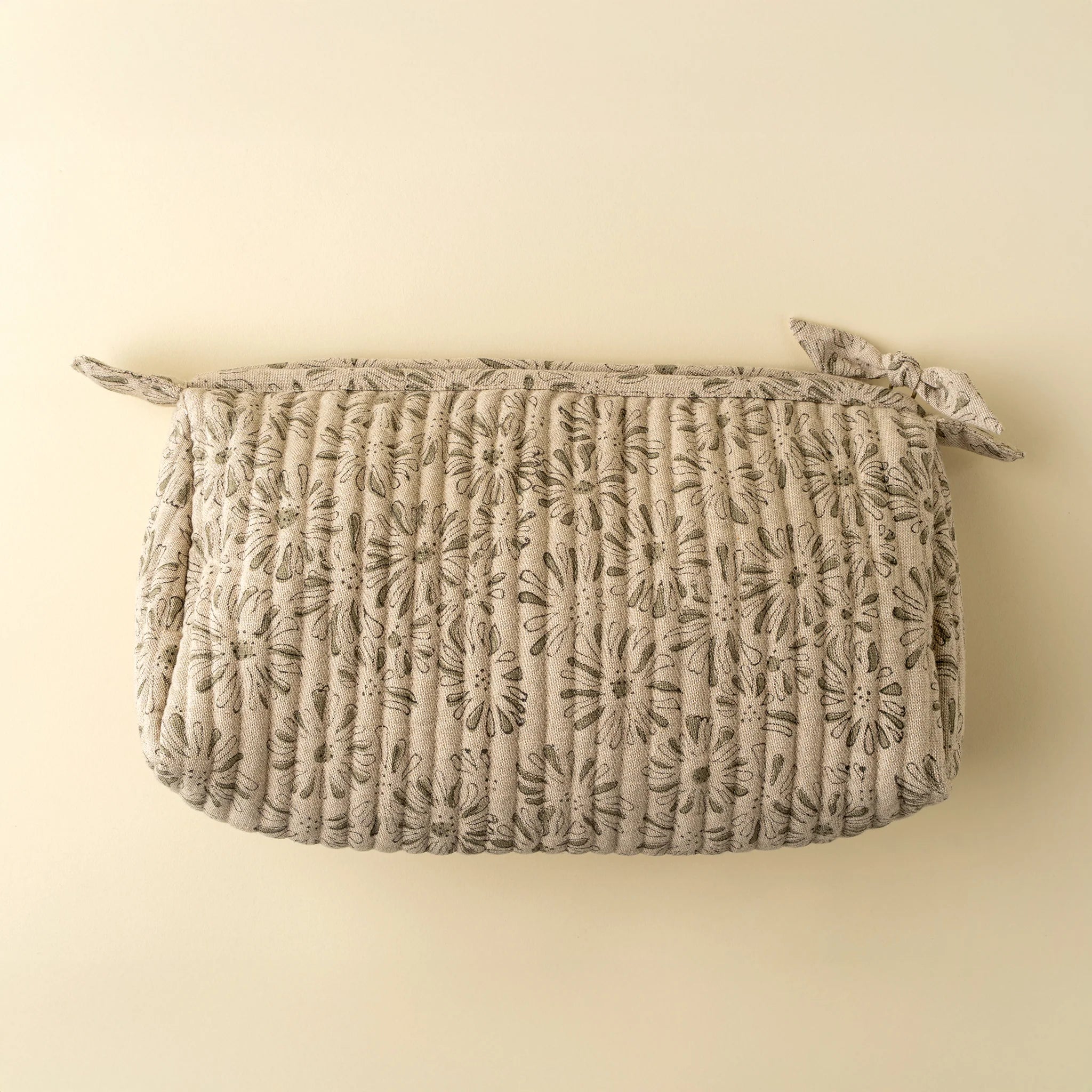 Textured woven basket with floral pattern on a beige background