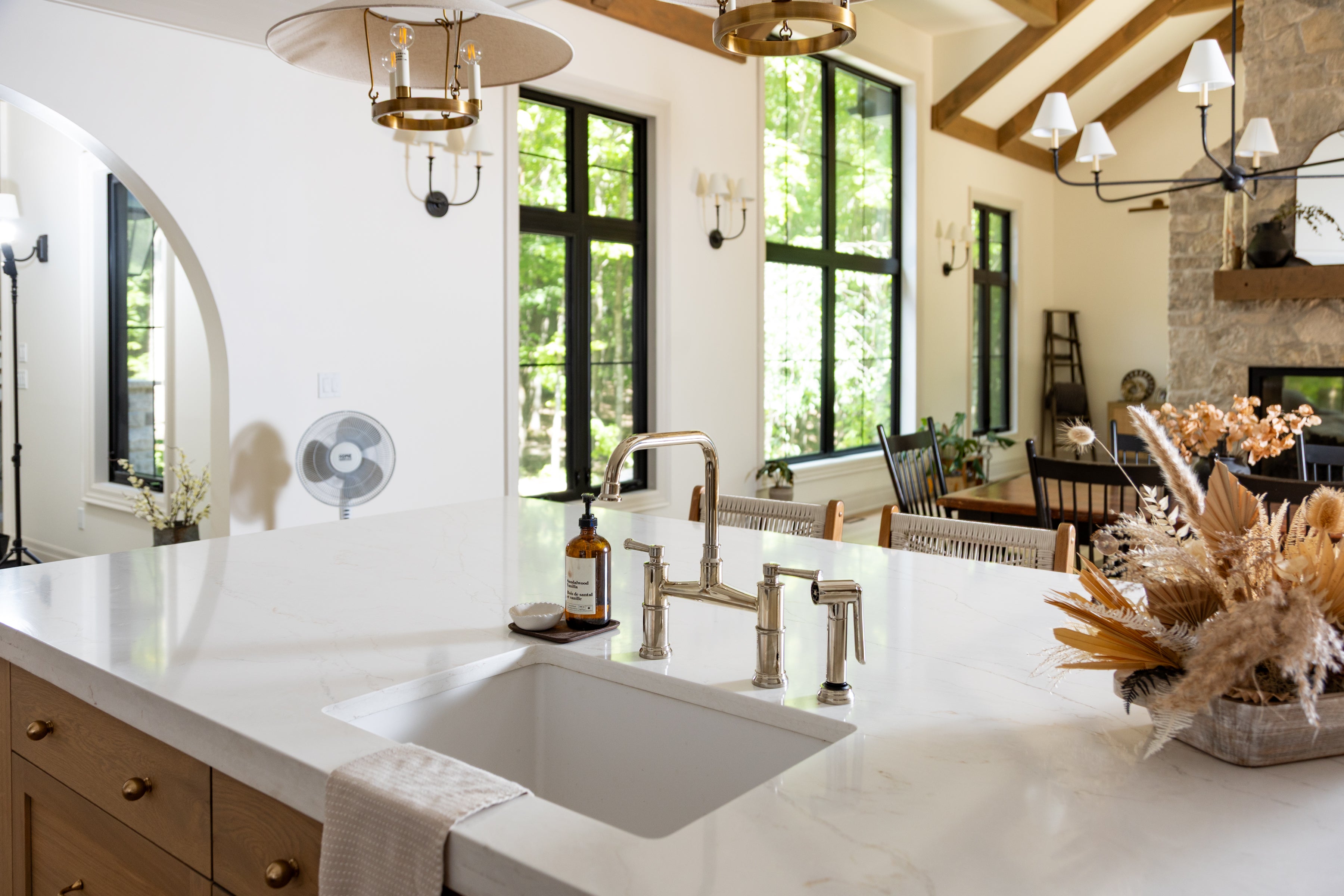 Modern kitchen with marble countertop, sink, and decorative elements.