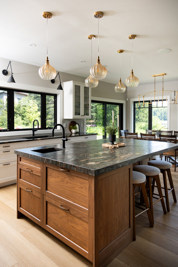 Modern kitchen with wooden island and pendant lights